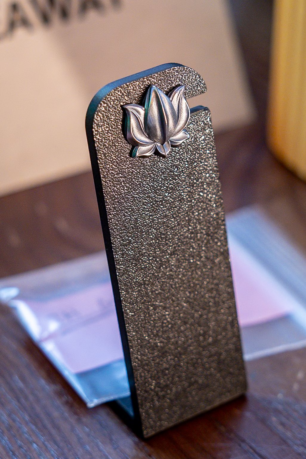 Lotus 001 mounted on a textured metal display stand