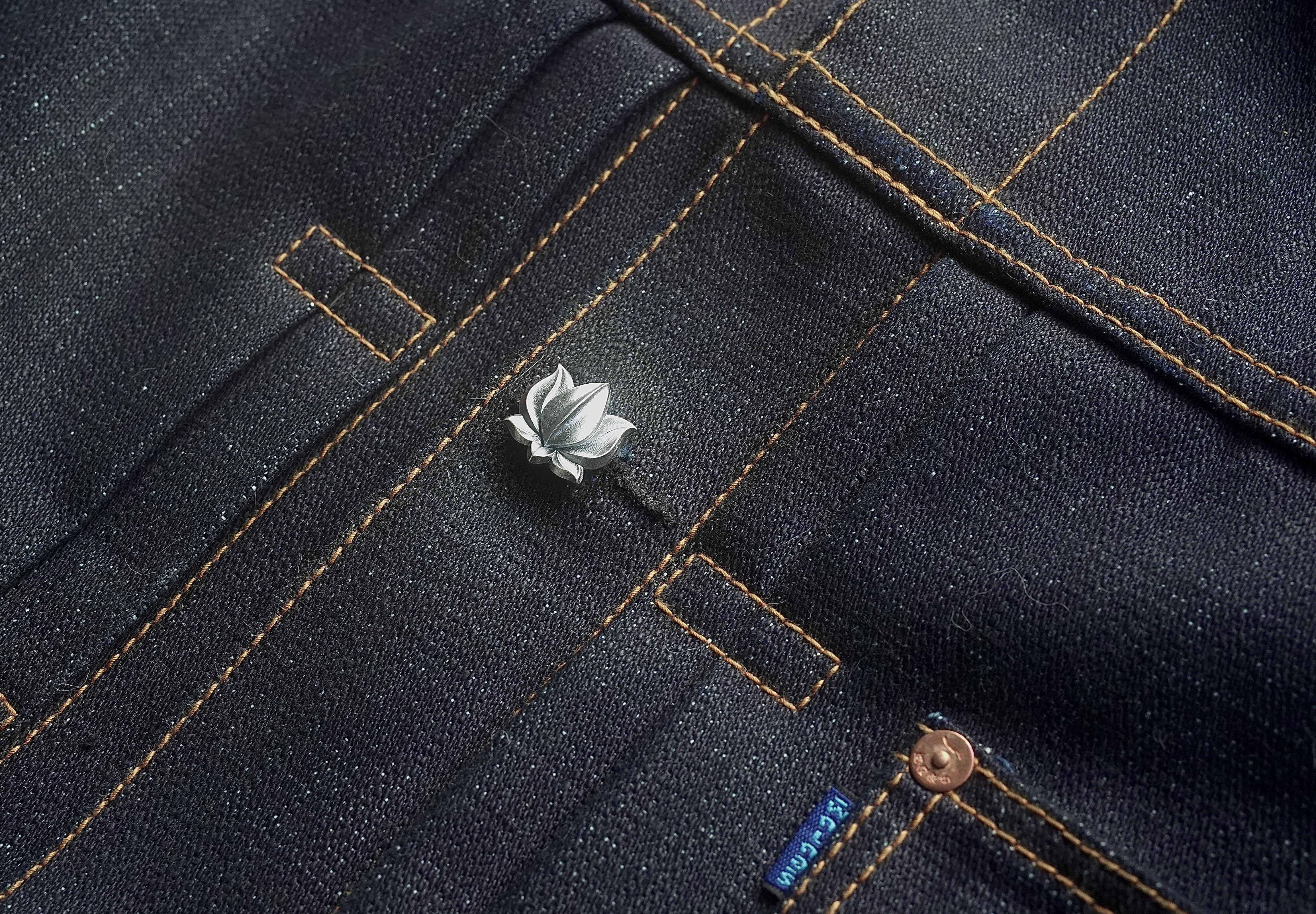 Sterling silver lotus in a selvedge denim buttonhole