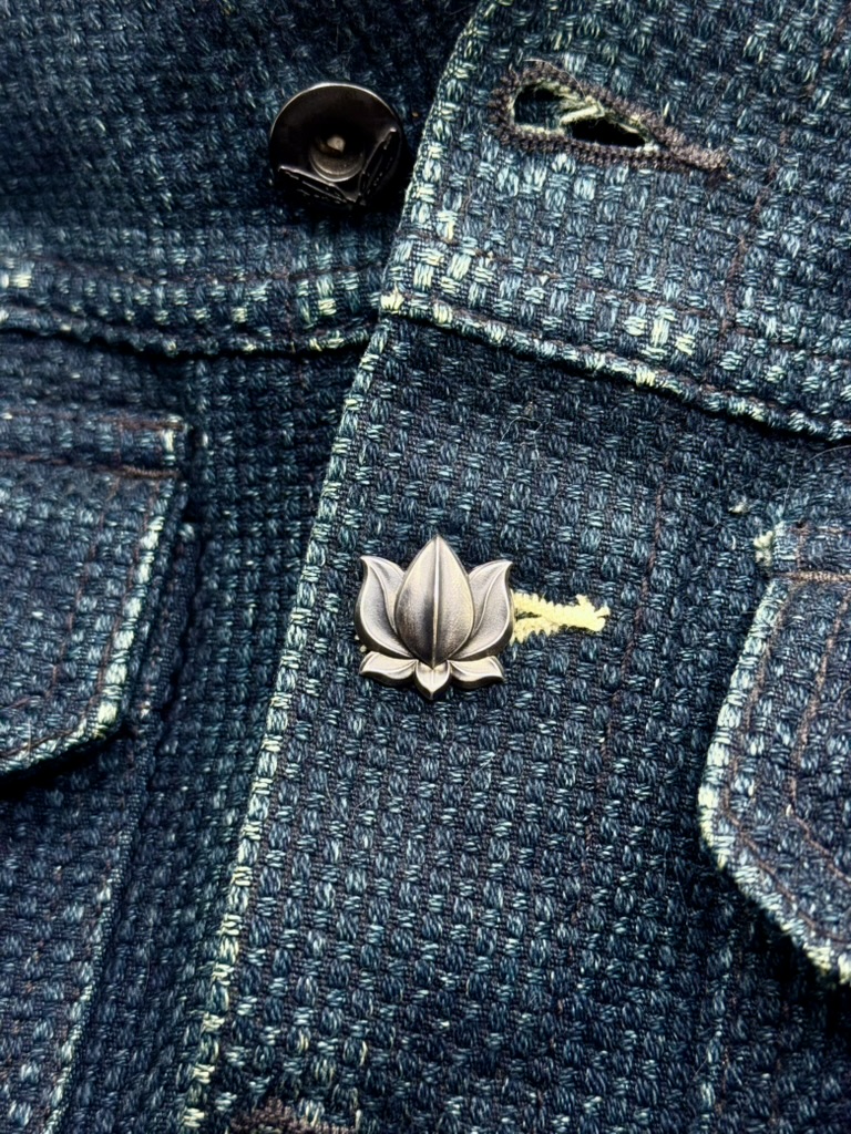 Lotus 001 seated in the existing buttonhole of a jacket placket